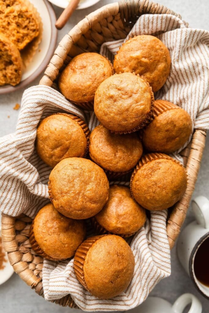 Easy Sweet Potato Muffin Recipe Overhead view of a basket filled with freshly baked Sweet Potato Muffins..