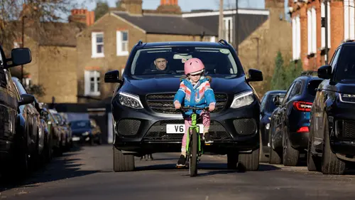 Children make their way to school surrounded by SUVs in London, England.This photograph is part of a new collection of images highlighting the impact of 'carspreading' on the school run taken by photographer Crispin Huges for Clean Cities.Carspreading is taking over our cities. Cars are getting bigger — about 1cm wider every two years. The thing is, our streets aren’t. More than half of new cars in Europe are too wide for urban parking spaces, leaving our cities crowded and congested. And carspreading is damaging our planet too - petrol and diesel SUVs burn around 20% more fuel, and electric SUVs require more resources and critical battery minerals.Clean Cities is Europe’s largest network of organisations dedicated to active, shared and electric urban mobility.